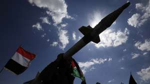 epaselect epa11970462 A Houthi supporter carries a mock missile as others wave the flags of Palestine (R) and Yemen (L) during a protest in Sana'a, Yemen, 17 March 2025 against US airstrikes on Houthi positions. Houthi supporters have taken to the streets of Sana'a to protest the airstrikes that targeted Houthi-held positions in several Yemeni cities on 15 March. The Houthis have vowed to target US ships in the Red Sea in retaliation for the recent US airstrikes that killed at least 53 people and wounded 98 others, according to a statement by Houthi military spokesman Yahya Sarea.  EPA/YAHYA ARHAB